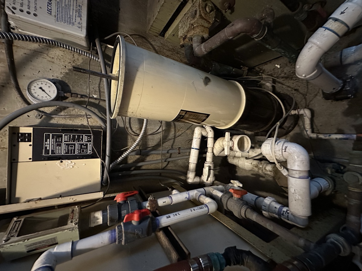 Aging pool equipment room with corroded plumbing found during an ASA Pools and Spas inspection in Seattle